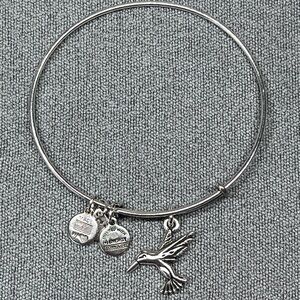 Alex and Ani silver tone bangle bracelet with hummingbird charm.